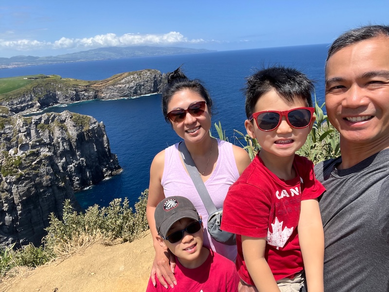 Justin with family at scenic coastal cliffs